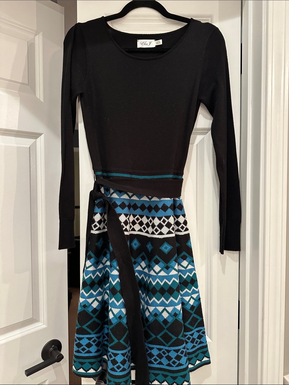 chic Black Knit Wrap Dress with Teal and White Geometric Skirt